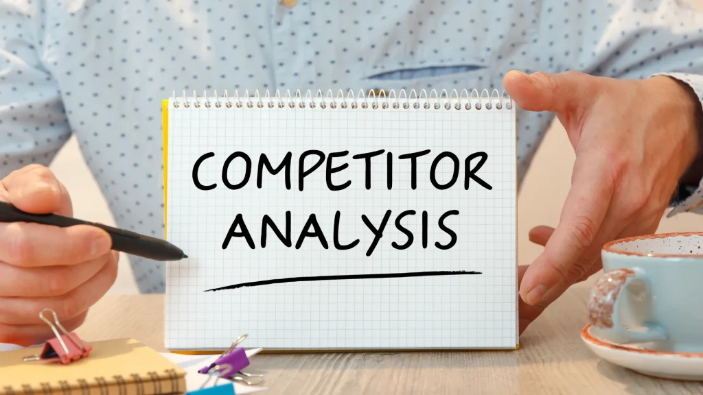 Person holding notebook with "Competitor Analysis" text, emphasizing the value of an SEO Competitor Analysis Report Template.